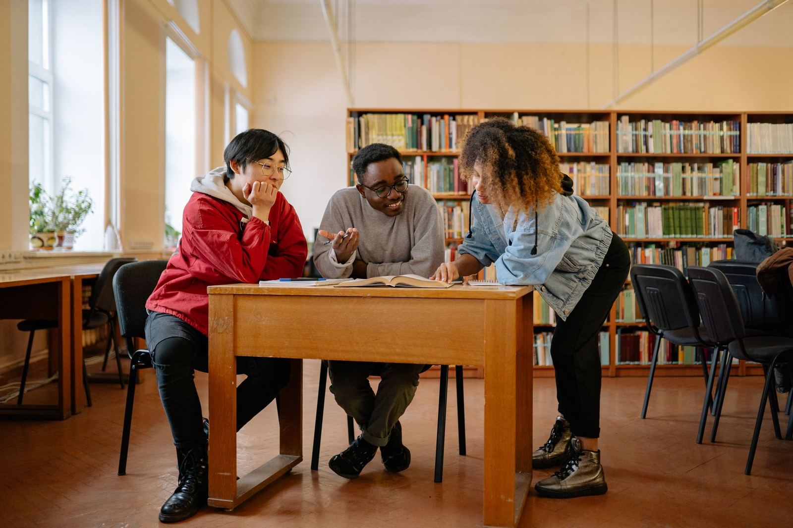 Learners studying together around a library table