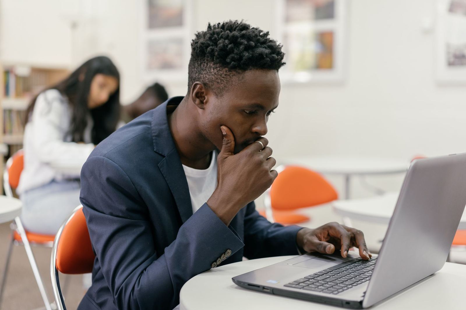 A teacher preparing an online lesson on a laptop
