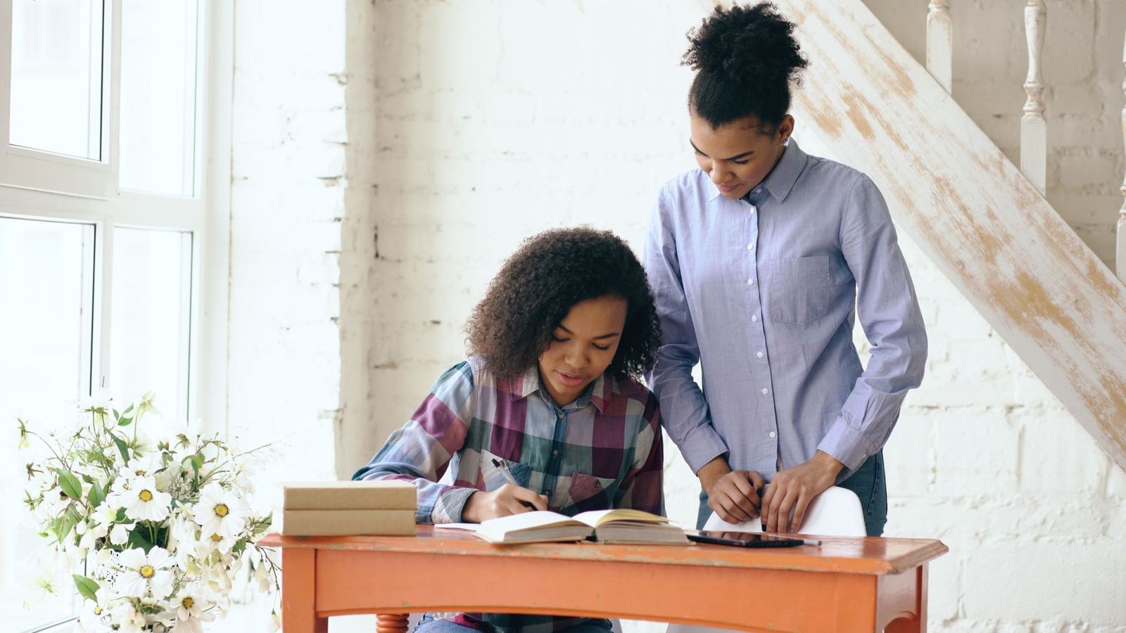 A mother helping her daughter with homework