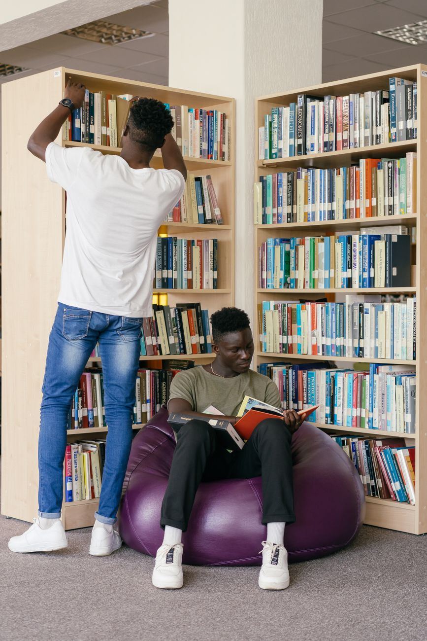 Students browsing books in a library